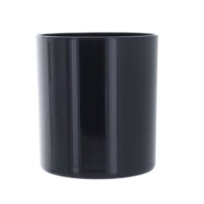 Black cylindrical candle vessel on a white background